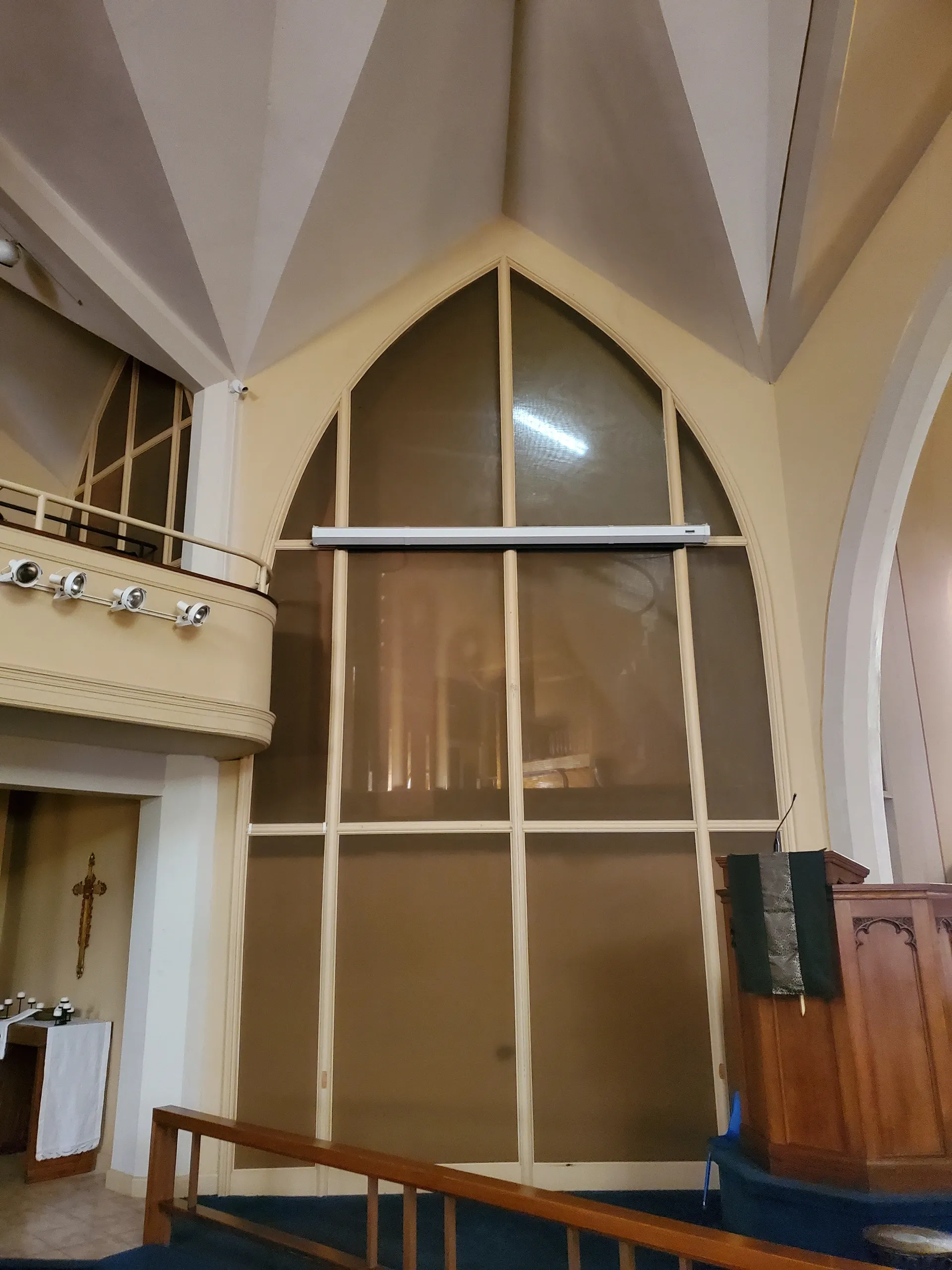 organ chamber lit up from sanctuary